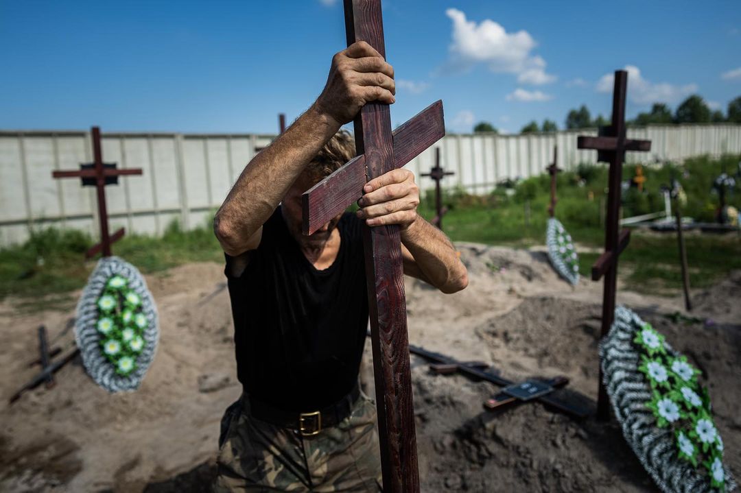 BUCHA, UKRAINE — With graves marked only with numbers, not names, burial serv...